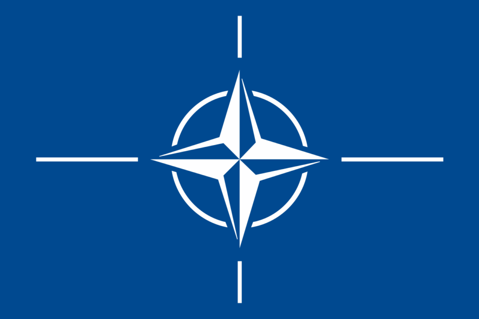 Blue NATO flag with white compass rose